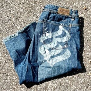 Y2K Rocawear blue jeans with white paint splatter logo and distressed details
